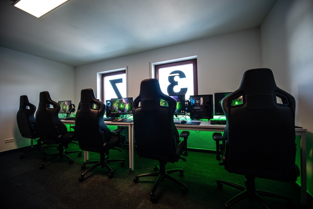 Gaming chairs with green rgb at a long desk